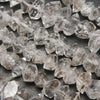 Double point terminated herkimer diamond quartz beads with dark inclusions.