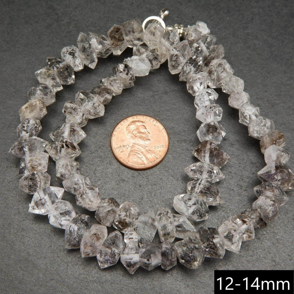 Double point terminated herkimer diamond quartz beads with dark inclusions.