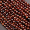 Close-up of red gemstone beads on a dark background