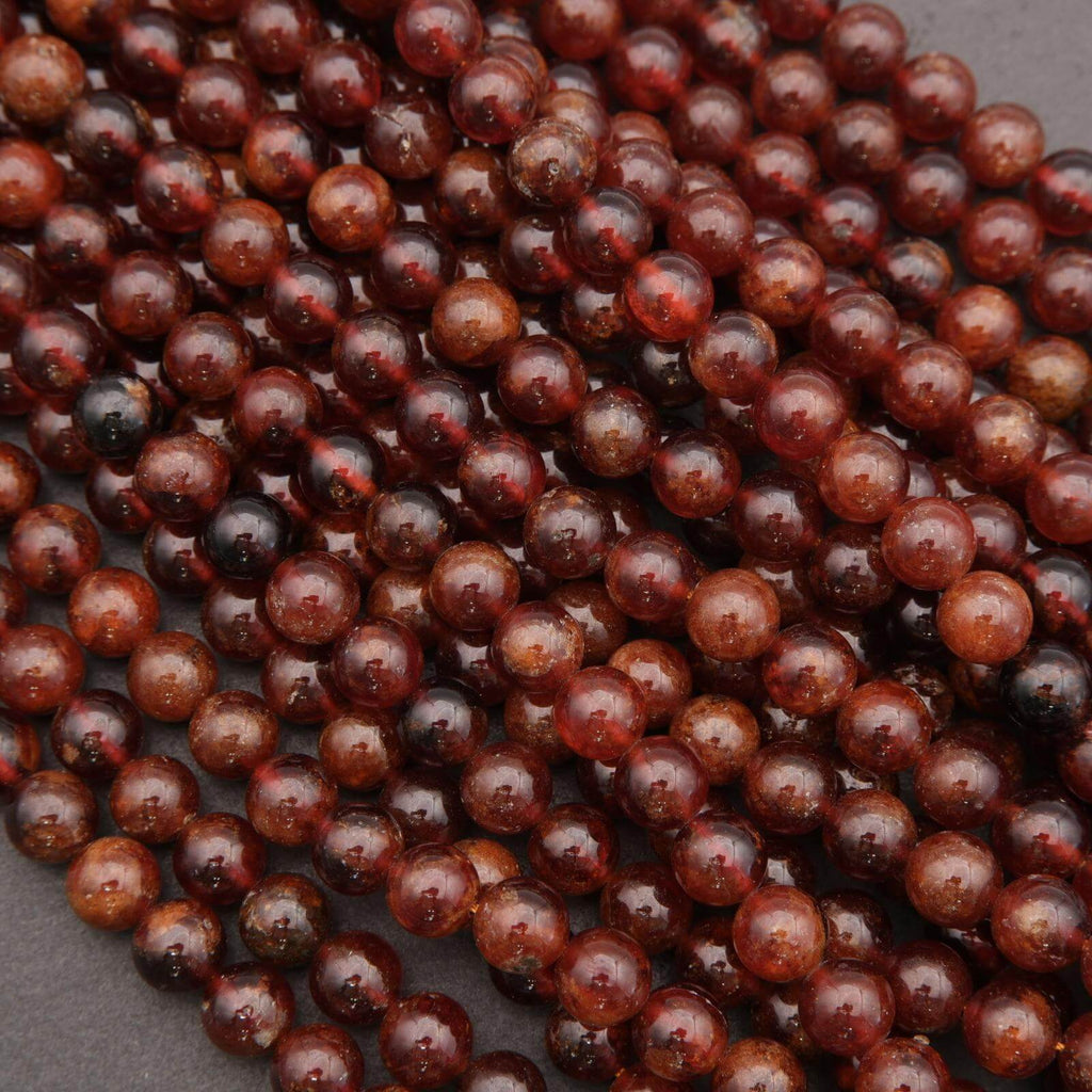 Close-up of red gemstone beads on a dark background