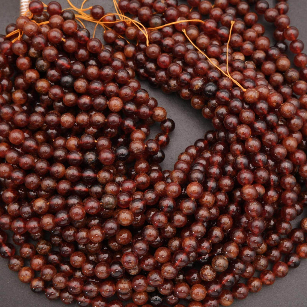 Close-up of a string of dark brown beads on a gray background