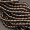 Close-up of a string of brown beads on a gray background