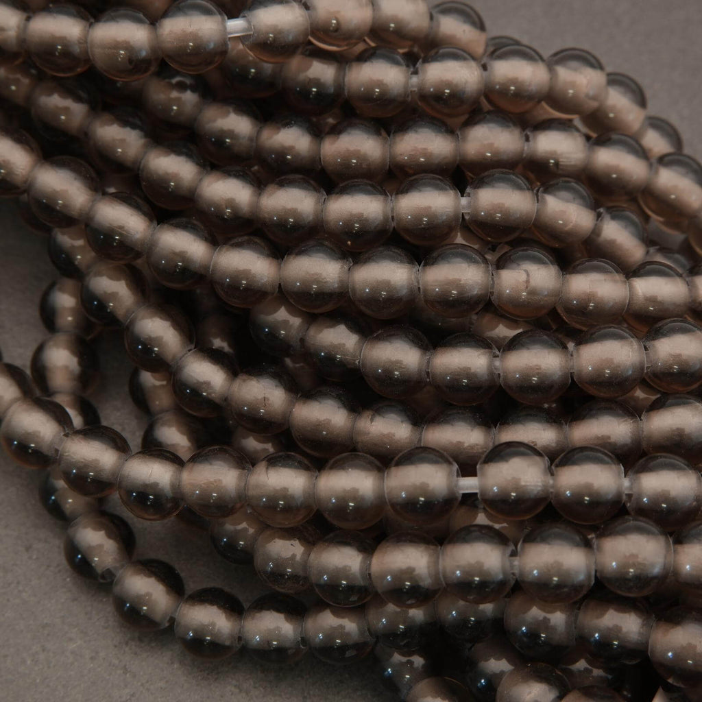 Close-up of a string of brown beads on a gray background