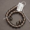 Beaded bracelet with a label on a gray background