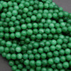 Close-up of green beads on a dark background