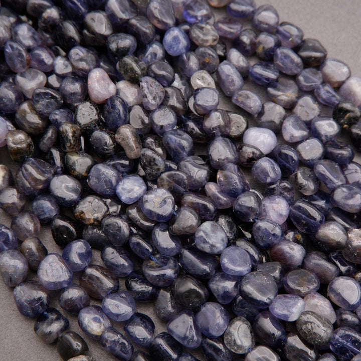 Close-up of purple and gray pebbles on a neutral background