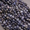Close-up of purple and gray pebbles on a neutral background