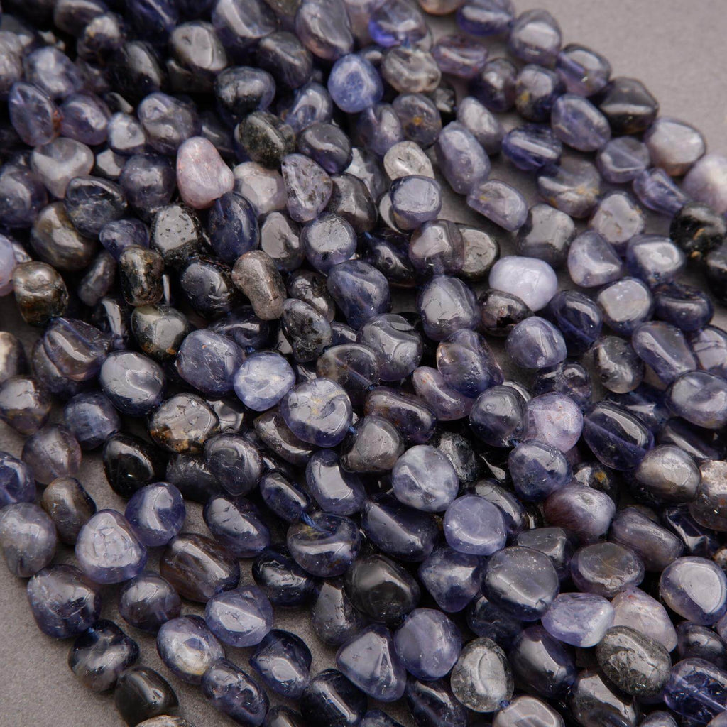 Close-up of purple and gray pebbles on a neutral background