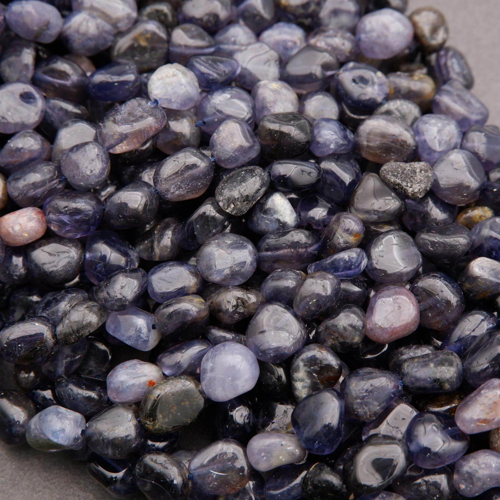 Close-up of purple and gray pebbles on a neutral background