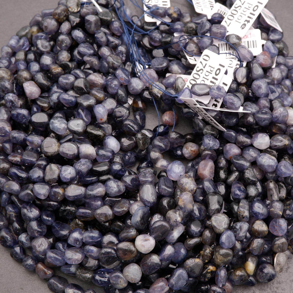 String of purple beads with visible labels on a gray surface