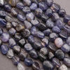 Close-up of purple and gray gemstones on a gray surface