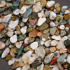 Close-up of multicolored pebbles on a dark surface