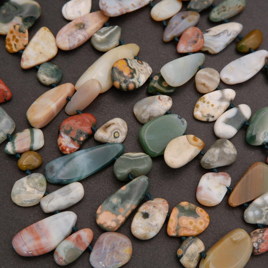 Assorted colorful stones on a dark surface