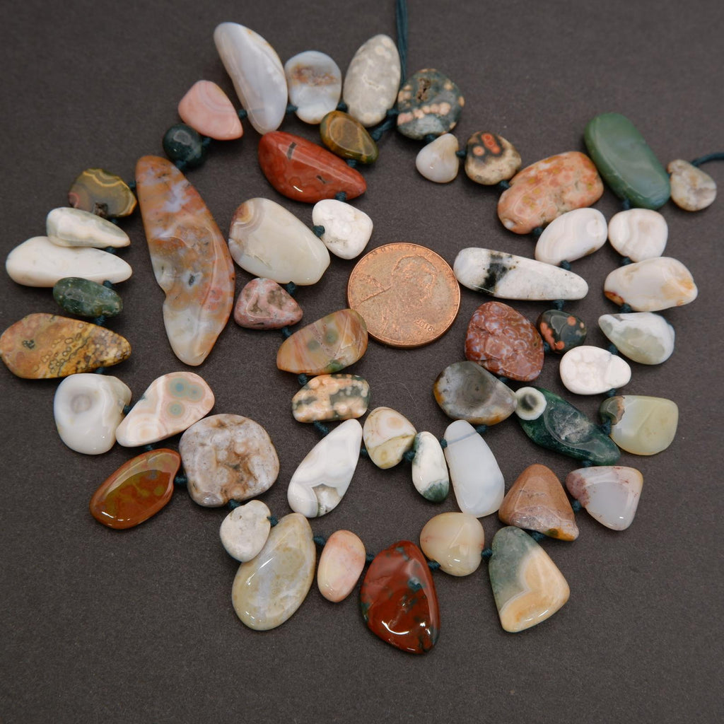 Assorted colorful pebbles on a dark surface