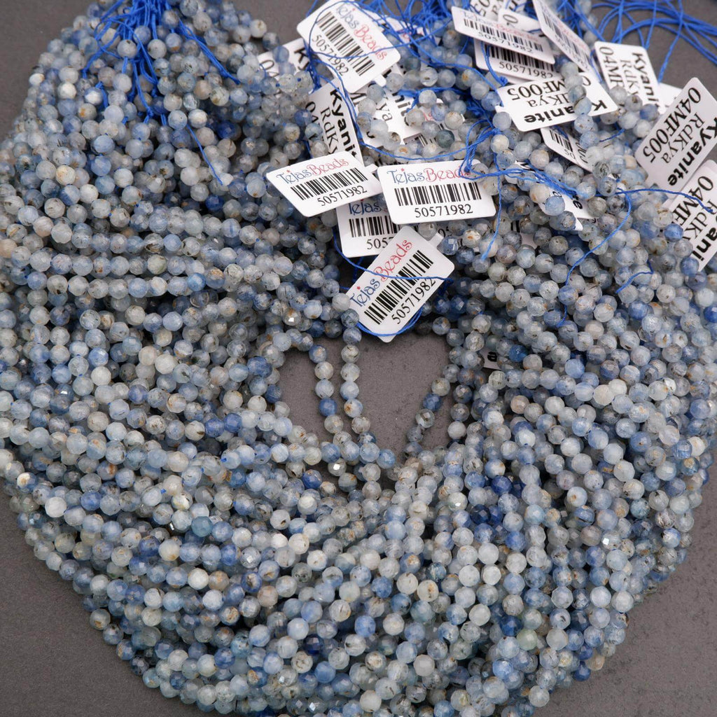 Multiple strands of light blue kyanite beads with smoky gray tones and reflective facets.