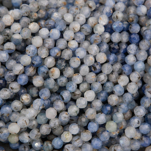 Multiple strands of light blue kyanite beads with smoky gray tones and reflective facets.