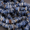 Close-up of blue and white stone beads on a dark surface