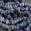 Close-up of blue and white stone beads on a dark surface