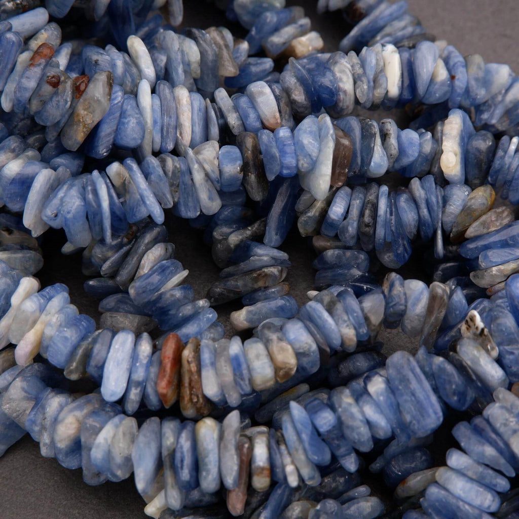 Close-up of blue and white stone beads on a dark surface
