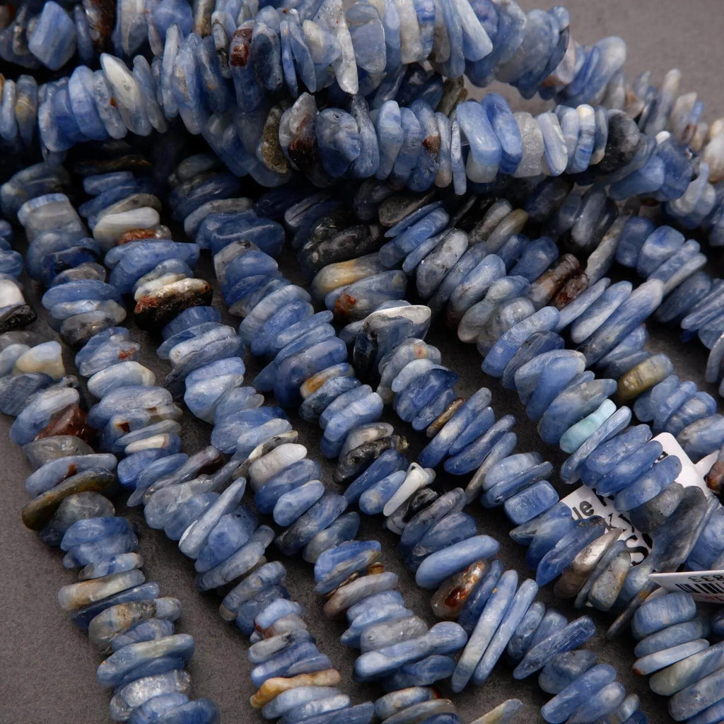 Close-up of blue stone beads on a gray surface