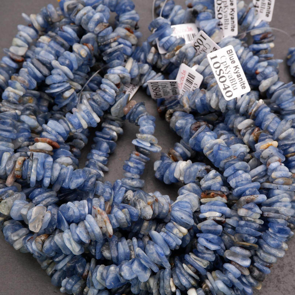 Blue stone beads with price tags on a gray surface