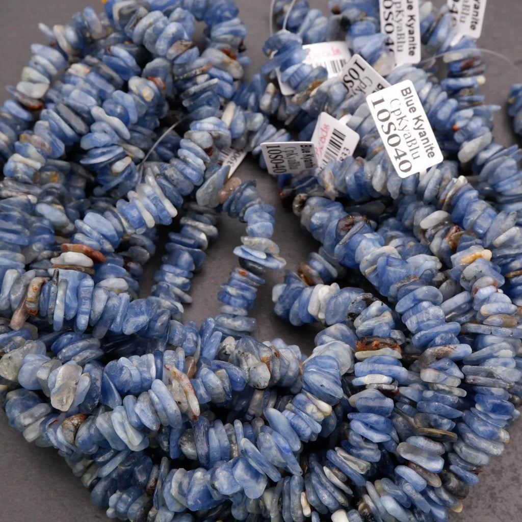 Blue stone beads with price tags on a gray surface