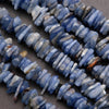 Close-up of blue stone beads on a dark surface