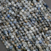 Close-up of small, multicolored beads on a gray surface