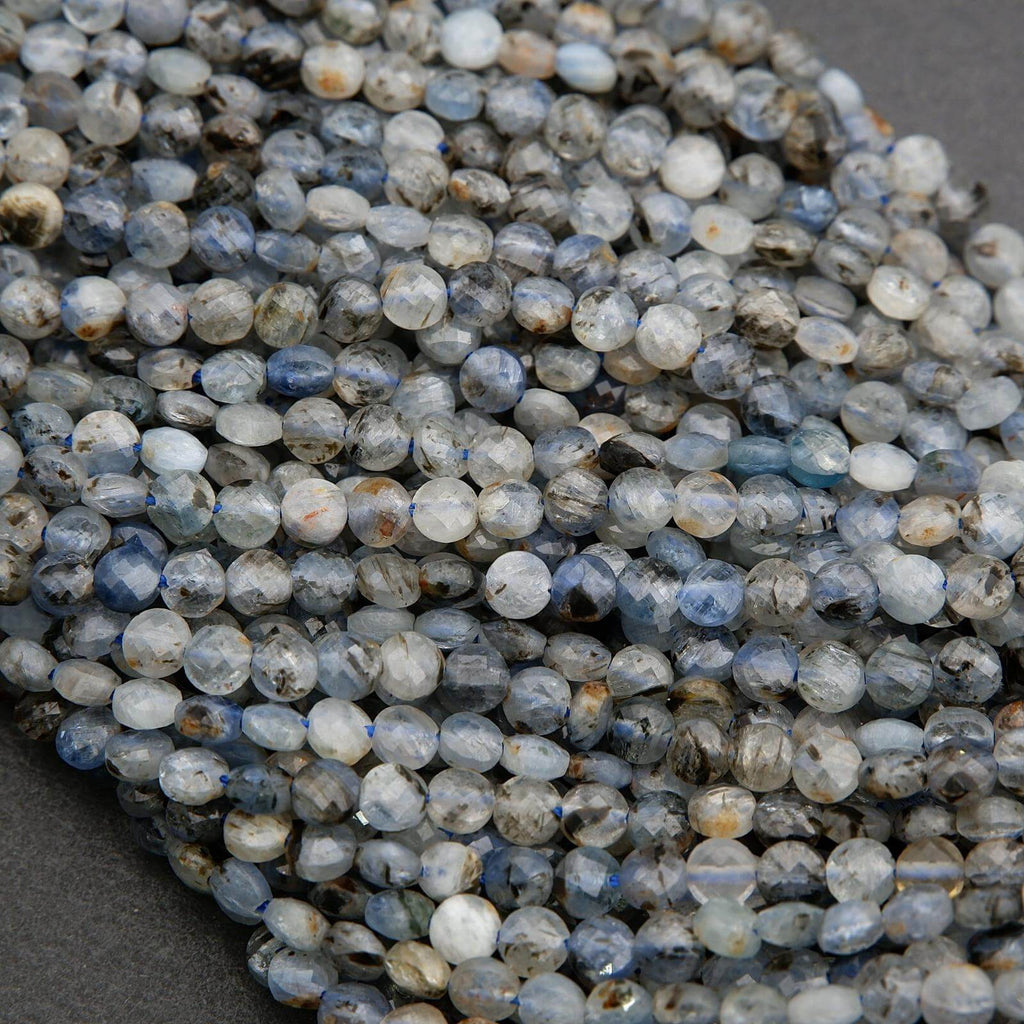 Close-up of blue and gray faceted beads on a dark background