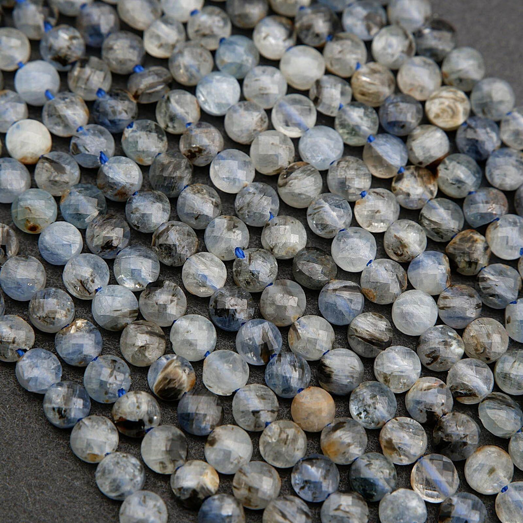 Close-up of faceted gemstones on a dark surface