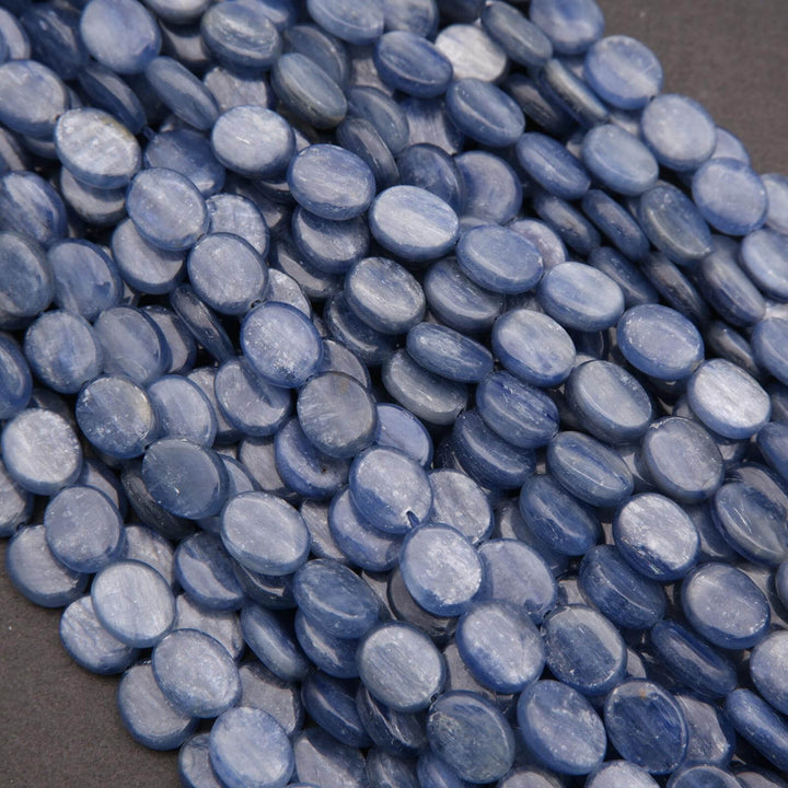 Close-up of blue oval beads on a dark background