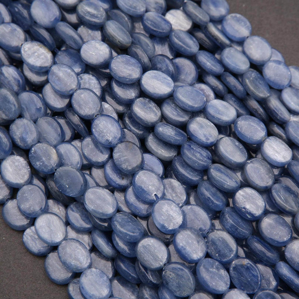 Close-up of blue oval beads on a dark background