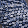 Close-up of blue marbled beads on a gray background