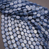 Close-up of blue oval beads on a gray background