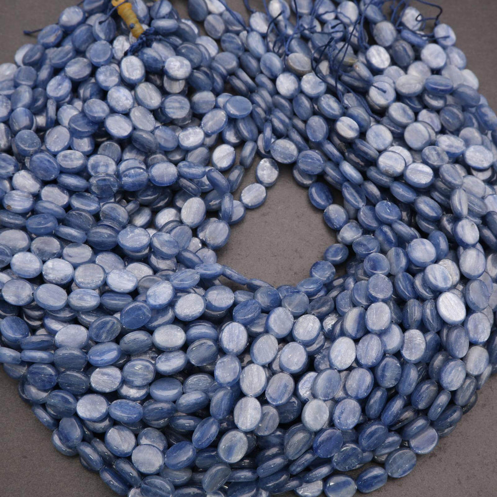 String of blue oval beads on a gray background