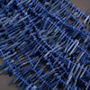 Close-up of blue plastic toothpicks on a brown surface