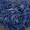 Close-up of blue plastic spikes on a gray background
