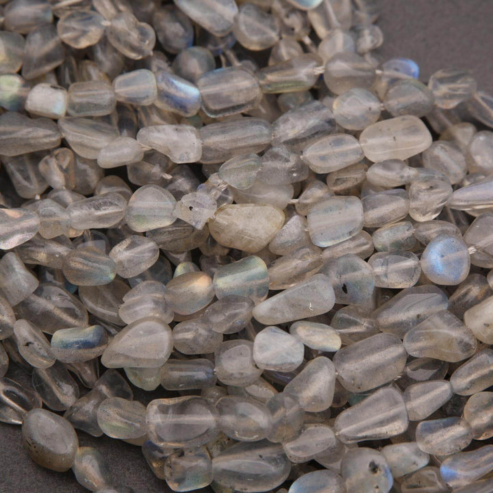 Close-up of translucent gray beads on a dark surface