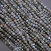 Close-up of small, round, multicolored beads on a neutral background