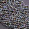 Close-up of light blue faceted beads on a gray background