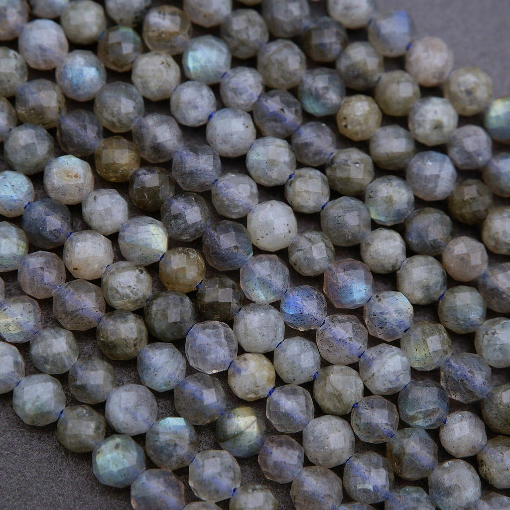Close-up of faceted gemstones on a textured surface