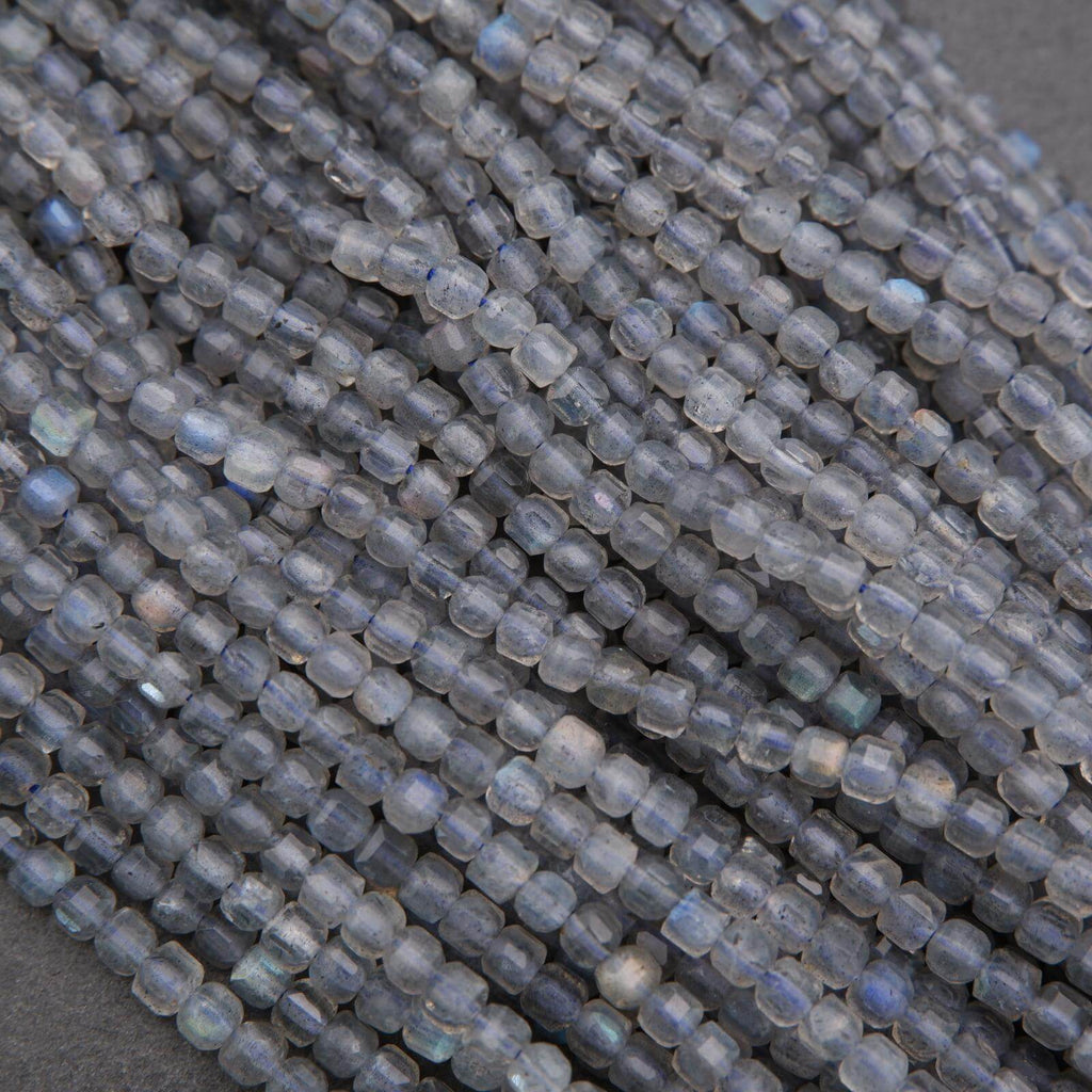 Close-up of a string of small, round, gray beads on a dark background