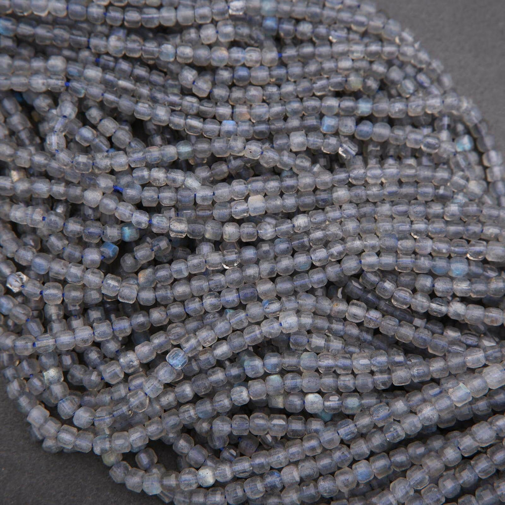 Close-up of a string of small blue beads on a dark background