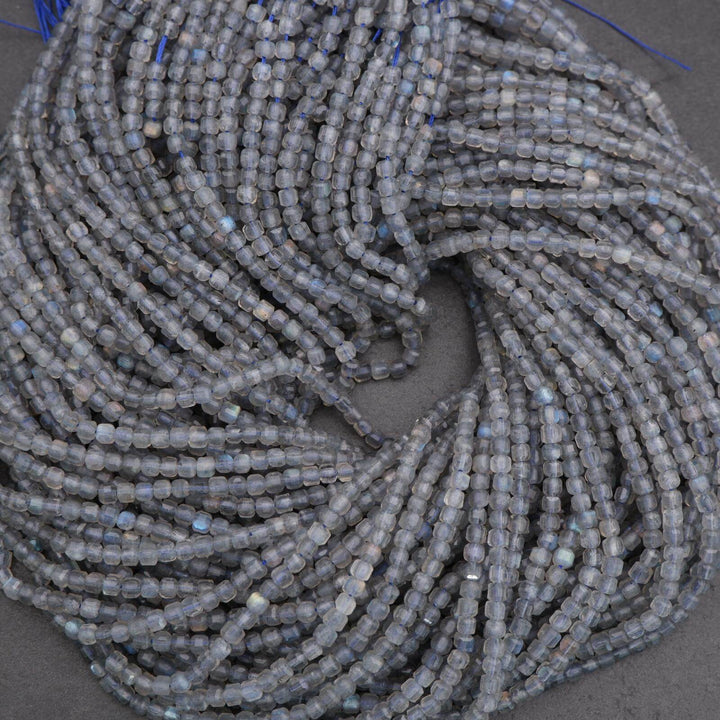 Close-up of a string of small gray beads on a dark surface