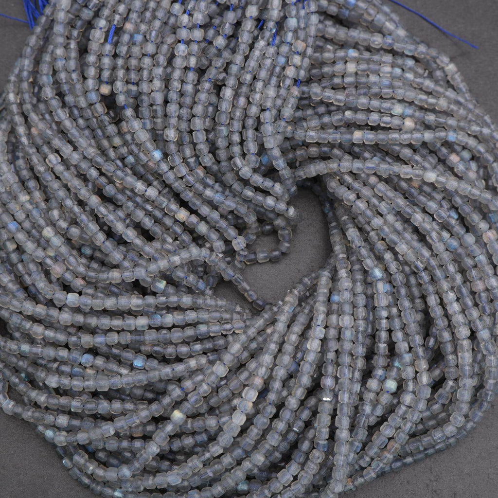 Close-up of a string of small gray beads on a dark surface