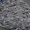 Close-up of a string of small, round, gray beads.