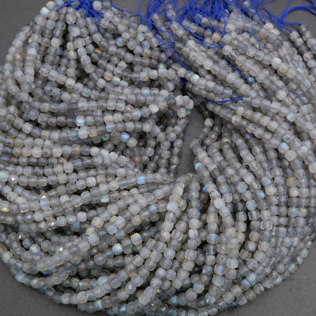 String of small gray beads with blue string on a gray background
