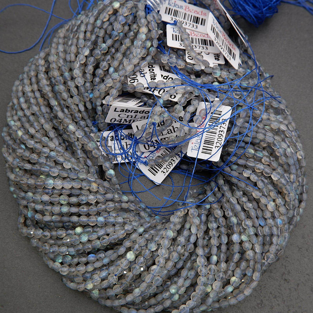 Coiled string of blue beads with labels on a gray background