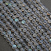 Close-up of transparent blue gemstone beads on a dark background