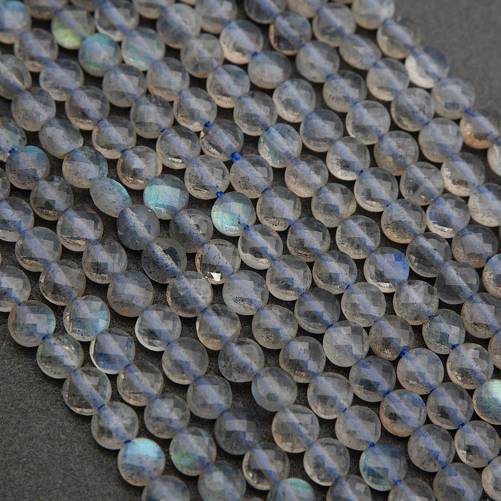 Close-up of transparent blue gemstone beads on a dark background